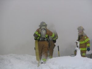 Firefighters walking in to smoke